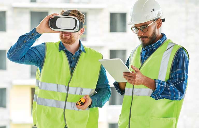 Man in visibility vests wearing hardhats and using a VR headset